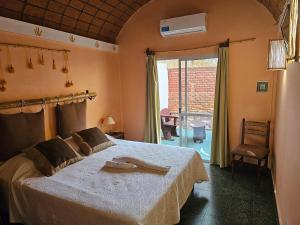 a bedroom with a large bed and a window at Los Toneles Cafayate in Cafayate