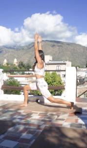 a woman doing yoga on a bench next to a pool at Los Toneles Cafayate in Cafayate