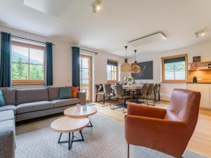 a living room with a couch and a table at Riesner Alpenlodge in Donnersbachwald
