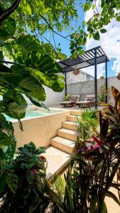 a pool with stairs and a pergola in a garden at Private House with Pool, 2 Bedrooms & Parking in Valladolid
