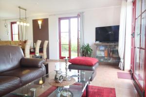 a living room with a couch and a tv at Haus an der Wiek in Wohlenberg