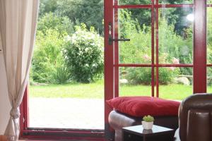 a living room with a door open to a garden at Haus an der Wiek in Wohlenberg