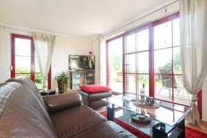 a living room with a couch and a glass table at Haus an der Wiek in Wohlenberg