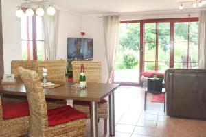 a living room with a dining room table and chairs at Haus an der Wiek in Wohlenberg