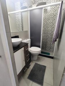 a bathroom with a toilet and a sink and a shower at Recanto de Paz Lapa - RJ in Rio de Janeiro +32 photos