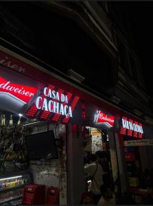 a coca cola sign on the side of a store at Recanto de Paz Lapa - RJ in Rio de Janeiro