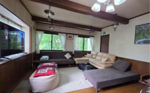 a living room with a couch and a table at Wolke Lodge in Shinano