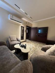 a living room with two couches and a table at فندق اسيل نجمة واحدة in Salhabah