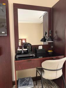 a hotel room vanity with a mirror and a chair at فندق اسيل نجمة واحدة in Salhabah +43 photos