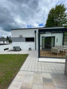 a house with a patio and a bench on a patio at Ferienbungalow Ochsenkopf in Gefrees
