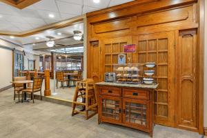 a restaurant with wooden walls and tables and chairs at Best Western Plus Wooster Hotel & Conference Center in Wooster