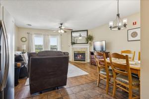 a dining room and living room with a table and a fireplace at WP141 City Lights in Pigeon Forge