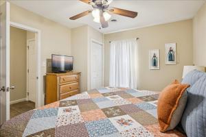 a bedroom with a bed and a ceiling fan at WP141 City Lights in Pigeon Forge +32 photos