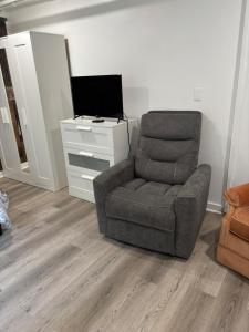 a living room with a chair and a television at dary hause in Indianapolis