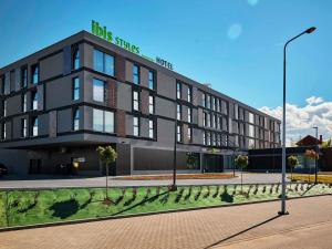 a black building with a sign on top of it at ibis Styles Nowy Targ in Nowy Targ