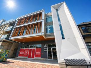 a building with a red door in front of it at Perfect Brand New Studio Downtown Sidney in Sidney