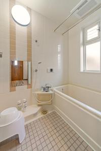 a bathroom with a tub and a toilet and a sink at Third Place Villa KISARAZU in Kisarazu +39 photos