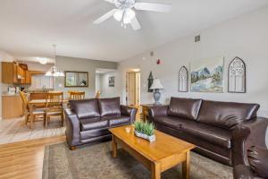 a living room with two leather couches and a table at WP521 We've Got It All in Pigeon Forge