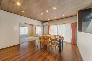 a living room with a dining room table and chairs at Third Place Villa KISARAZU in Kisarazu