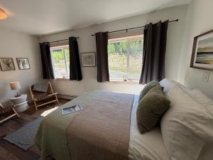 a bedroom with a bed and a window at Jasper East Hostel - Near Jasper National Park East Gate Entrance in Jasper