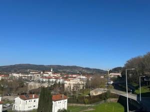 a view of a city with buildings and a blue sky at Bela vista AL in Paredes de Coura