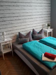 a bed with blue sheets and pillows in a room at Landhotel zur guten Quelle in Eisenach +43 photos