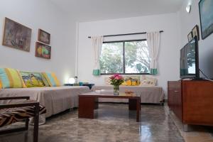 a living room with two beds and a coffee table at Casa de Campo con Vista al Mar in Tubará