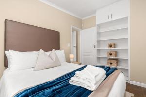 a bedroom with a large bed with white pillows at Sea Haven 4 in Gordonʼs Bay +46 photos
