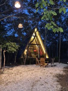 a tent in the woods at night at Chales Holanda in Pirenópolis