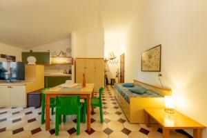 a kitchen and a living room with a table and a couch at Casa Anna in Paratico