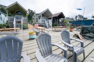 a group of chairs and tables on a deck at Emmanuel in Fort Bragg