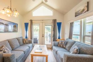 a living room with two couches and a table at Emmanuel in Fort Bragg