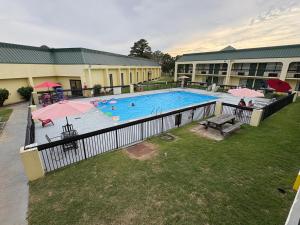 an overhead view of a swimming pool with umbrellas at Red Carpet Inn Kinston in Kinston
