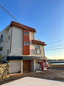 a building with a red and white at ハーミットクラブ in Goto
