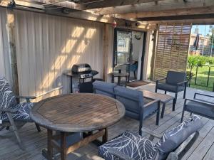 a patio with a table and chairs and a grill at Private Studio providing a comfortable space in Paraparaumu