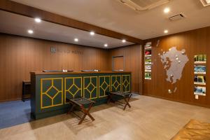 a waiting room with a counter and a world map on the wall at KOKO HOTEL Kumamoto Kamitori in Kumamoto +110 photos