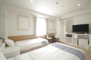 En eller flere senge i et værelse på Hotel Imalle Yokohama Isezakicho