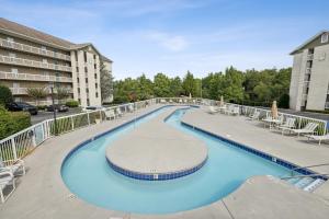 a large swimming pool with chairs and a building at WP231 Old Mill Overlook in Pigeon Forge