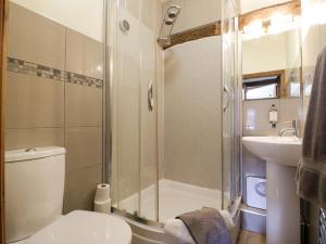 a bathroom with a shower and a toilet and a sink at Elmhurst Cottage in Quinton +36 photos