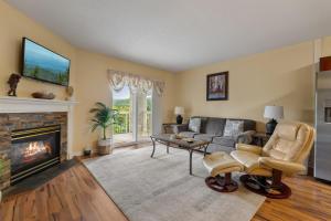 a living room with a couch and a fireplace at WP431 Private Sunsets in Pigeon Forge