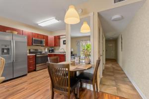 a kitchen with a wooden table and a refrigerator at WP431 Private Sunsets in Pigeon Forge