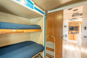 a small room with bunk beds and a tv at Poop Deck in Fort Bragg