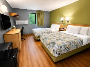 a hotel room with two beds and a television at Motel 6 Morehead, KY in Morehead +34 photos