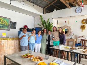 a group of people standing in a room with food at A-Manta Homestay in Labuan Bajo