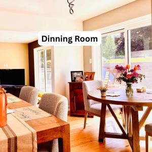 a living room with a dining room table and a dining room room at Oceanside Manor - Ocean View in Qualicum Beach