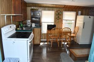 a kitchen with a white stove and a white refrigerator at Private Beach Access -Cottage 15 in Sauble Beach