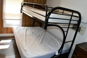 a couple of bunk beds in a room at Private Beach Access -Cottage 15 in Sauble Beach