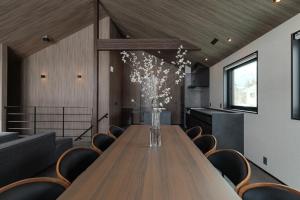 a conference room with a long wooden table and chairs at Forest Resort Walnut in Hakuba