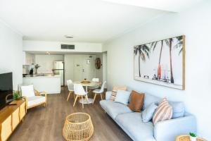 a living room with a couch and a table at Swell Resort Burleigh Heads in Gold Coast