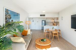 a living room with a couch and a table at Swell Resort Burleigh Heads in Gold Coast